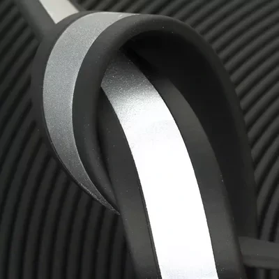 Close-up of Cyber Shadow reflective BioThane. Sleek black by day, brilliant white beacon by night with embedded high-visibility threading for safe late-night walks.