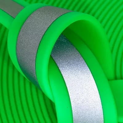 Close-up of Fusion Flash reflective BioThane. Radioactive neon green paired with reflective silver threading for a technical, high-contrast safety look.
