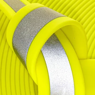 Close-up of Glow Runner reflective BioThane. High-vis neon yellow with active reflective technology—the gold standard for visibility in all weather conditions.
