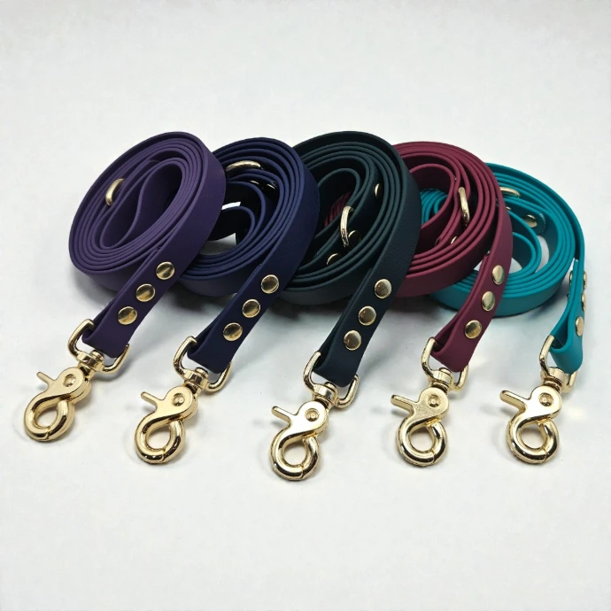 A collection of five fanned-out waterproof BioThane dog leads in the Signature Collection palettes, showcasing premium stink-proof gear for active dogs.