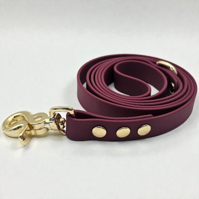 Handcrafted Porto burgundy BioThane dog lead on a white background—stink-proof, waterproof, and durable gear in a rich aubergine jewel tone.