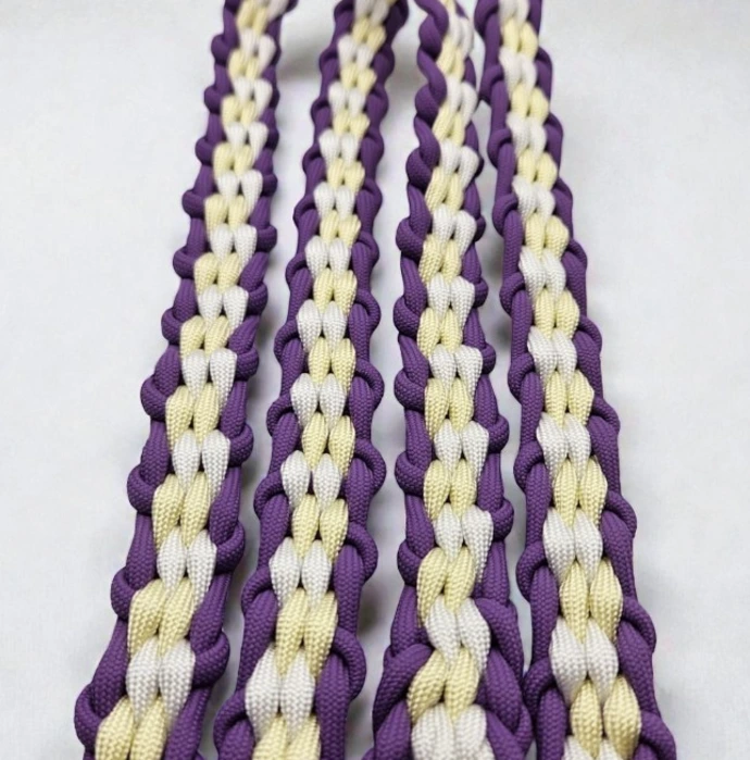 Close-up of Braided Paracord 550 English Reins in Lilac Bloom, featuring a purple, yellow, and white weave. Handcrafted rope gear for horses, offering durability and colourful horse reins.