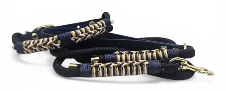 Handcrafted waterproof dog lead made from navy BioThane and premium rope, accented with gold and white braiding. Features solid brass hardware for durability and style. Easy to clean, durable, and custom-made for a practical unique touch.