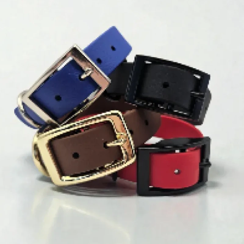 Four handcrafted BioThane® dog collars in blue, black, brown, and red, each featuring sturdy metal hardware in gold or black. Waterproof, stink-proof, and easy to clean, these bespoke collars combine durability with vibrant colour choices, showcasing the quality and style of Ponies &amp; Pups’ made-to-order gear.