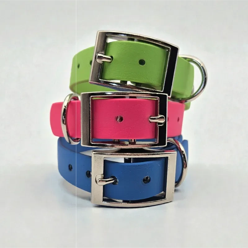Three handcrafted BioThane® dog collars in green, pink, and blue, each featuring a durable silver buckle and D-ring. Waterproof, stink-proof, easy to clean, and available in bright custom colours. Perfect for stylish, practical pet owners.