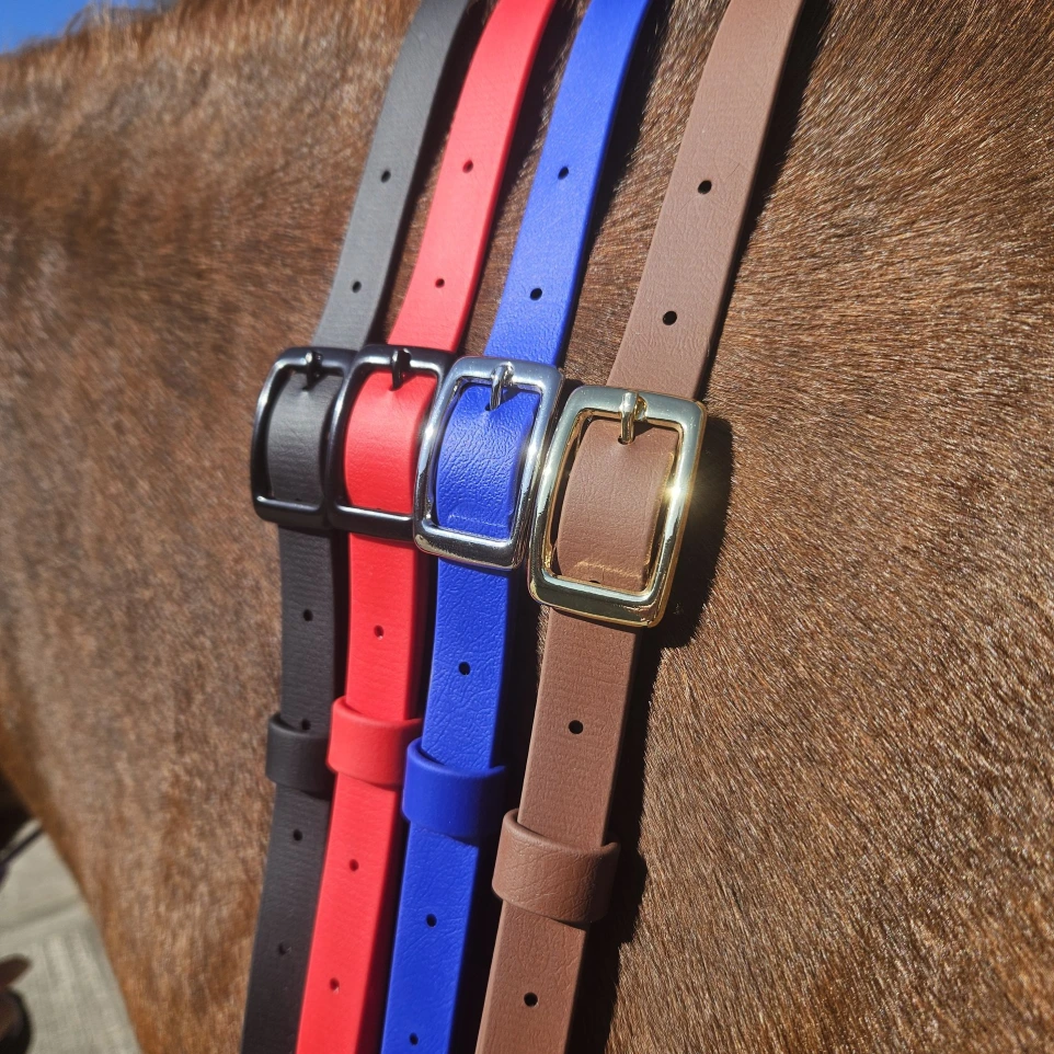Four handcrafted BioThane® horse neck straps in black, red, blue, and brown are displayed on a horse’s coat, showcasing both matte black and shiny metal buckles. Each collar features premium waterproof, easy-clean material, demonstrating the vibrant custom colours and durable hardware available through Ponies & Pups.